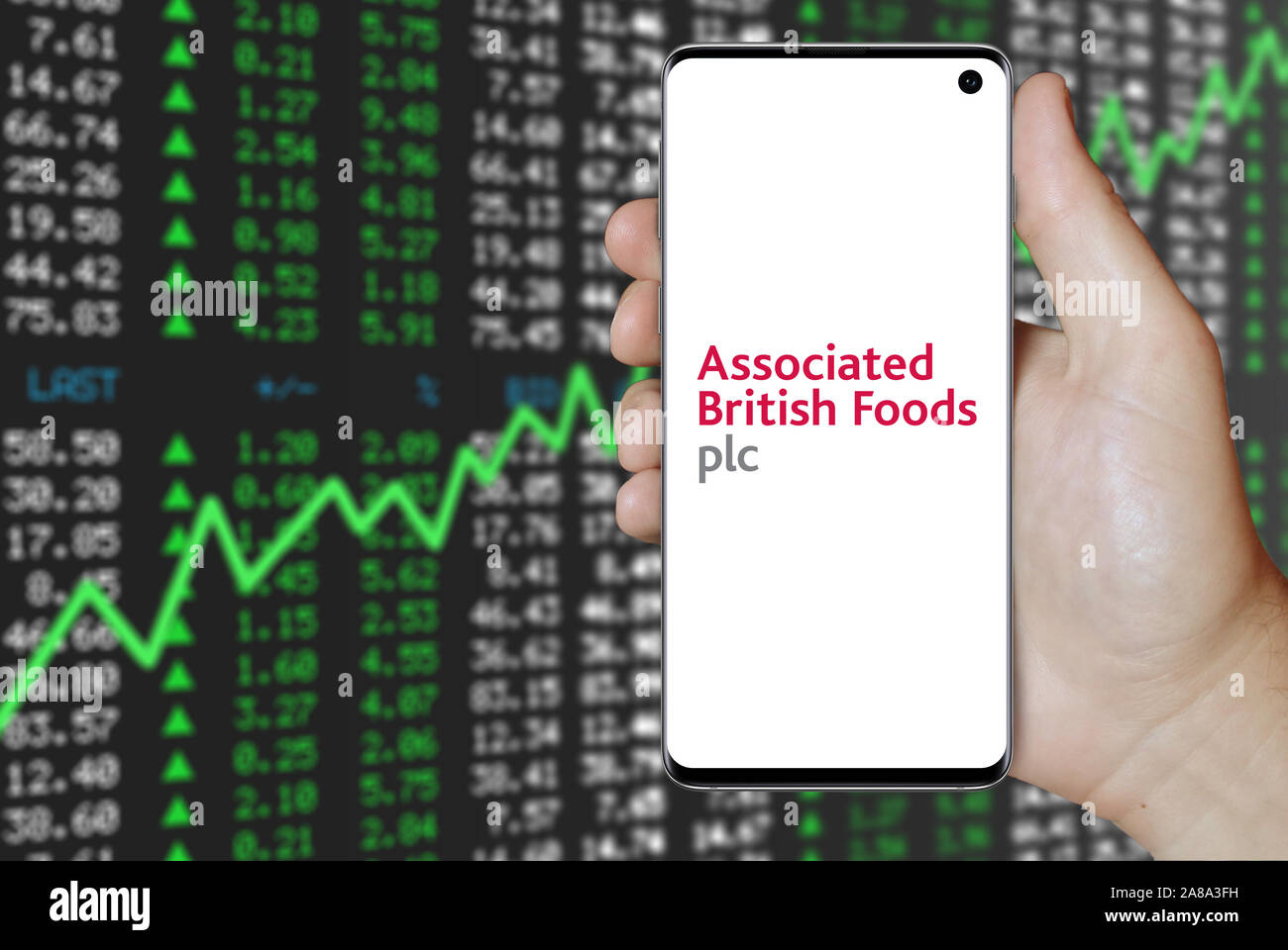 Logo of public company Associated British Foods displayed on a smartphone. Positive stock market background. Credit: PIXDUCE Stock Photo