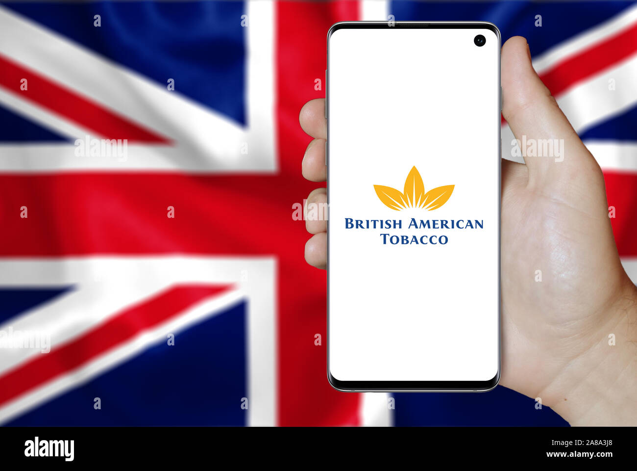 Logo of public company British American Tobacco displayed on a smartphone. Flag of UK background. Credit: PIXDUCE Stock Photo