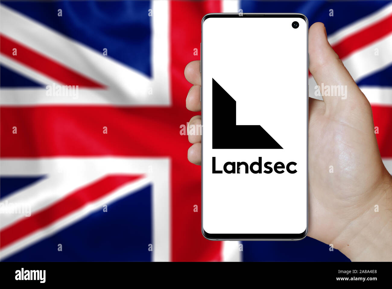 Logo of public company Land Securities displayed on a smartphone. Flag of UK background. Credit: PIXDUCE Stock Photo