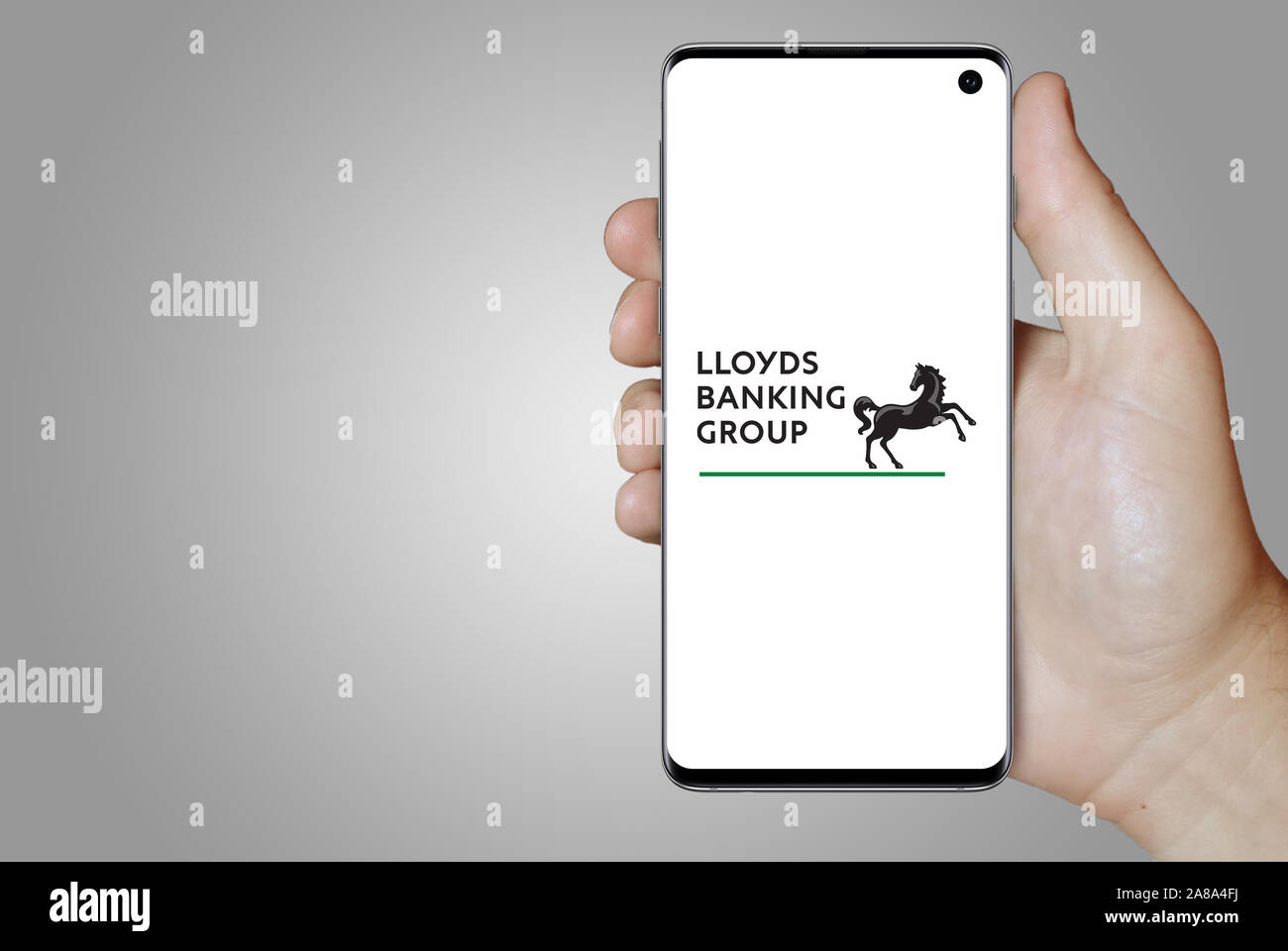 Logo of public company Lloyds Banking Group displayed on a smartphone. Grey background. Credit: PIXDUCE Stock Photo