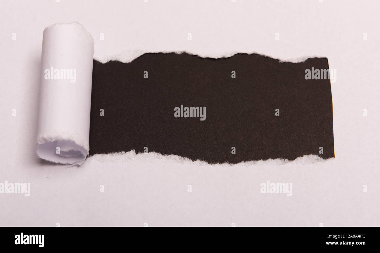 white torn paper with space for text with black background color. Hidden message. Secret. Copy space Stock Photo