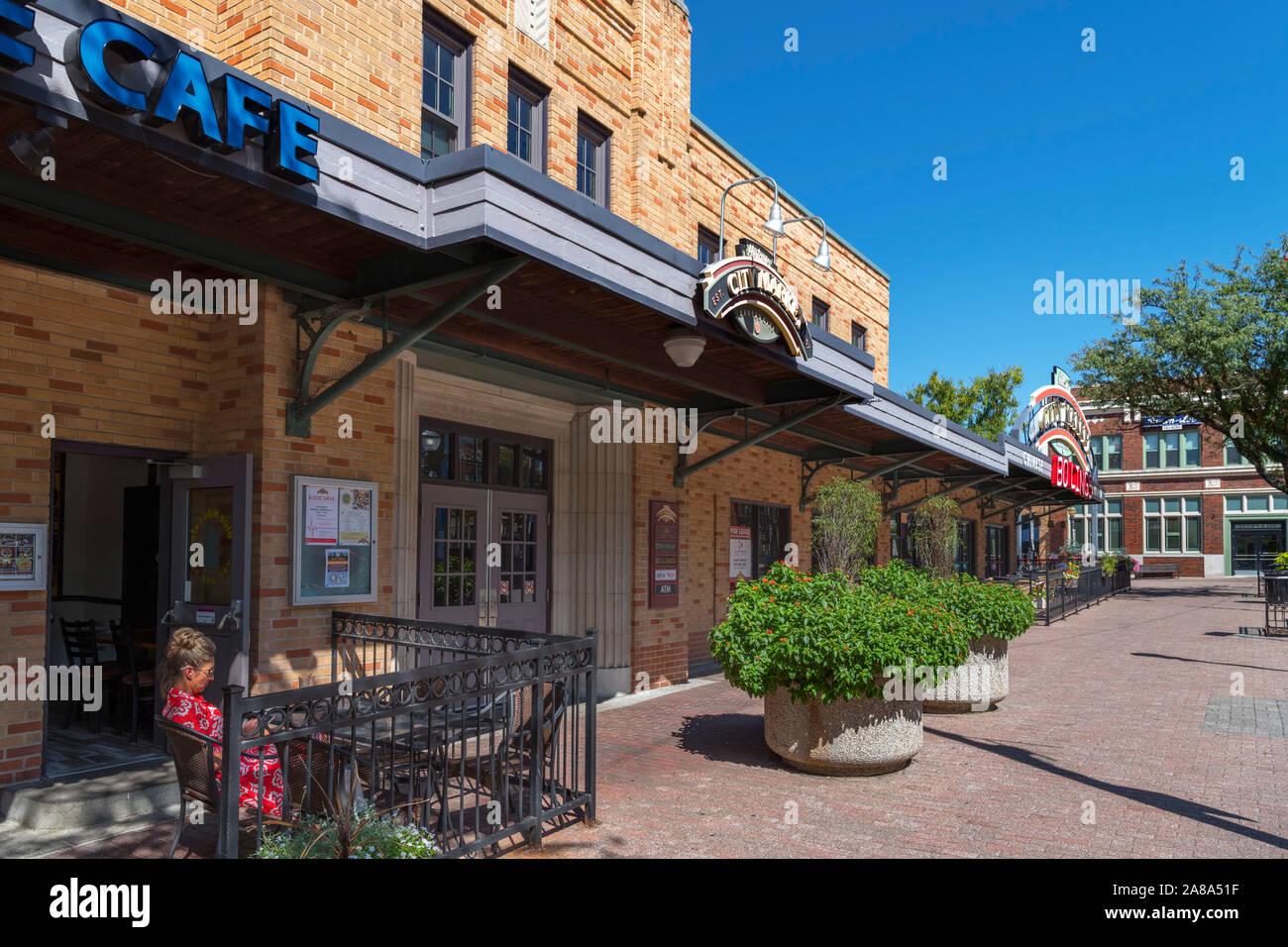 Woman sitting outside the Blue Nile Cafe in the City Market, River Market district, Kansas City, Missouri, USA Stock Photo