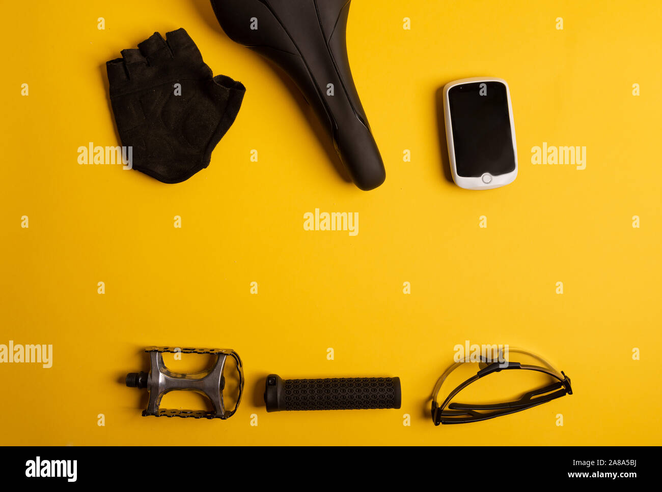 Bicycle, Cycling accessories on the yellow background. view from above