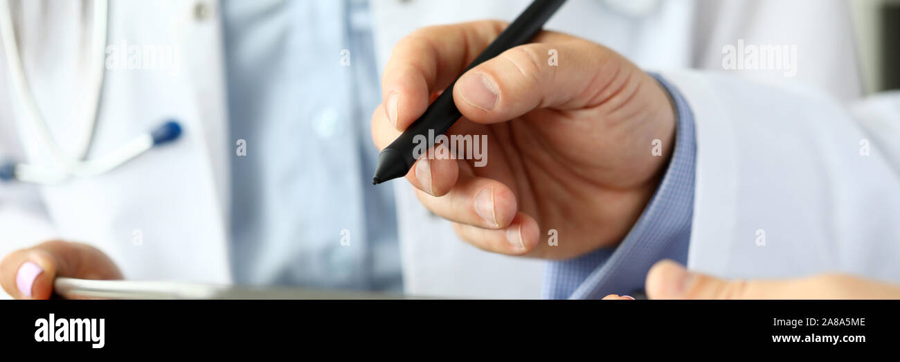 Male GP making electronic notes in tablet pc Stock Photo Alamy