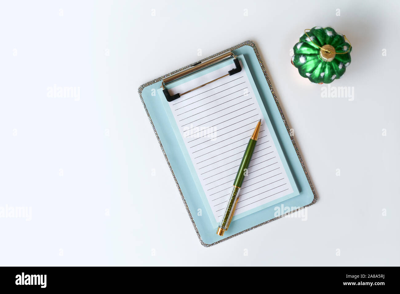 Clipboard blue with a silver trim and leaves in a strip for recording notes Stock Photo