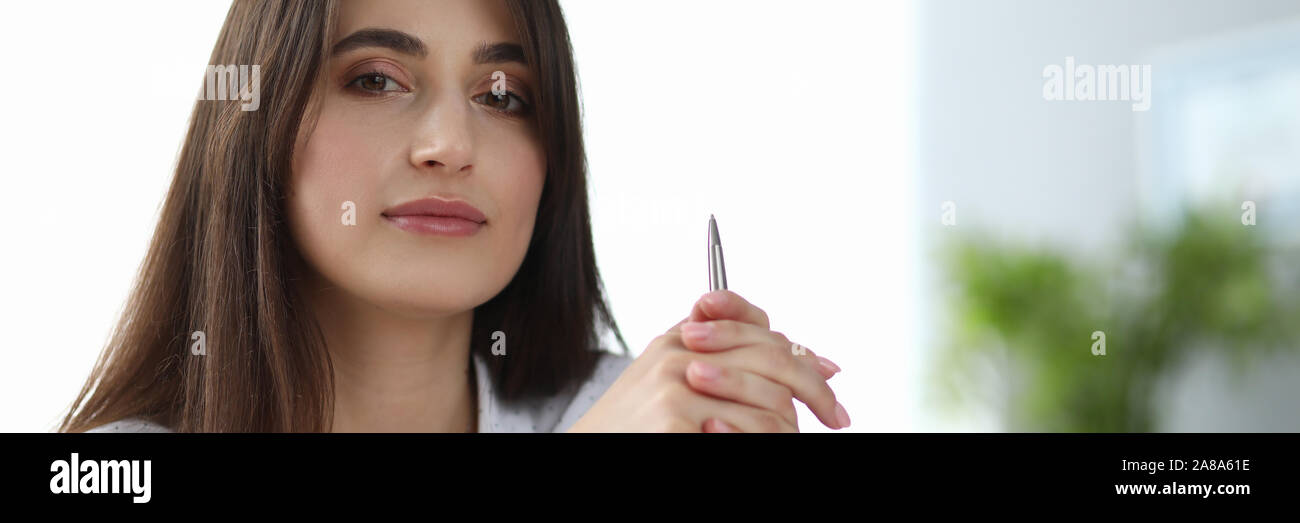 Cute woman holding pencil Stock Photo - Alamy