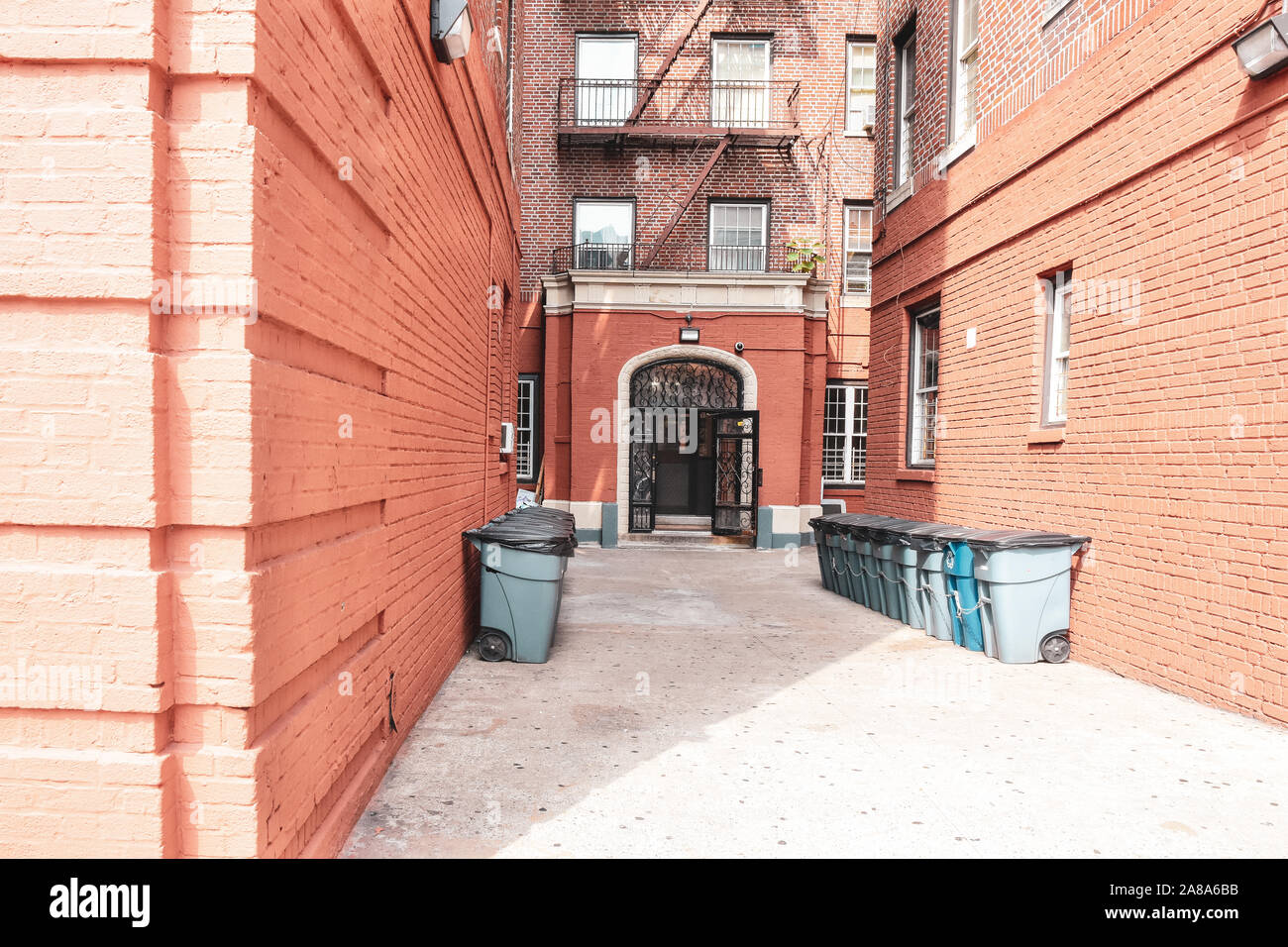 Three Metal Trash Cans Outside In Front Of A Brick Residential Building In  Astoria Queens New York Stock Photo - Download Image Now - iStock