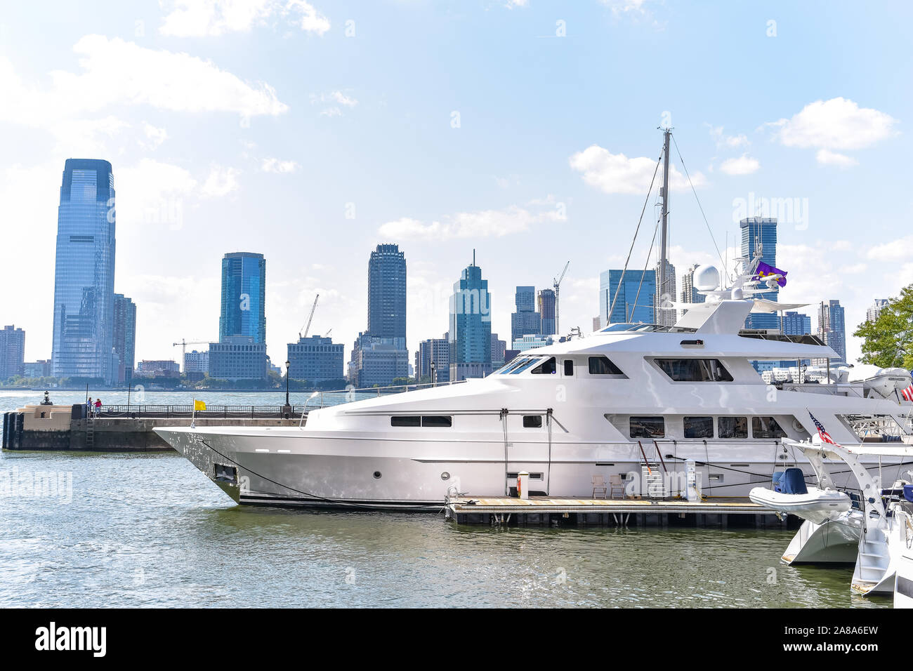 New Jersey skyline from Battery Park in a sunny day. Luxury yacht in the foreground. City, travel and luxury concept. Manhattan, New York City, USA. Stock Photo