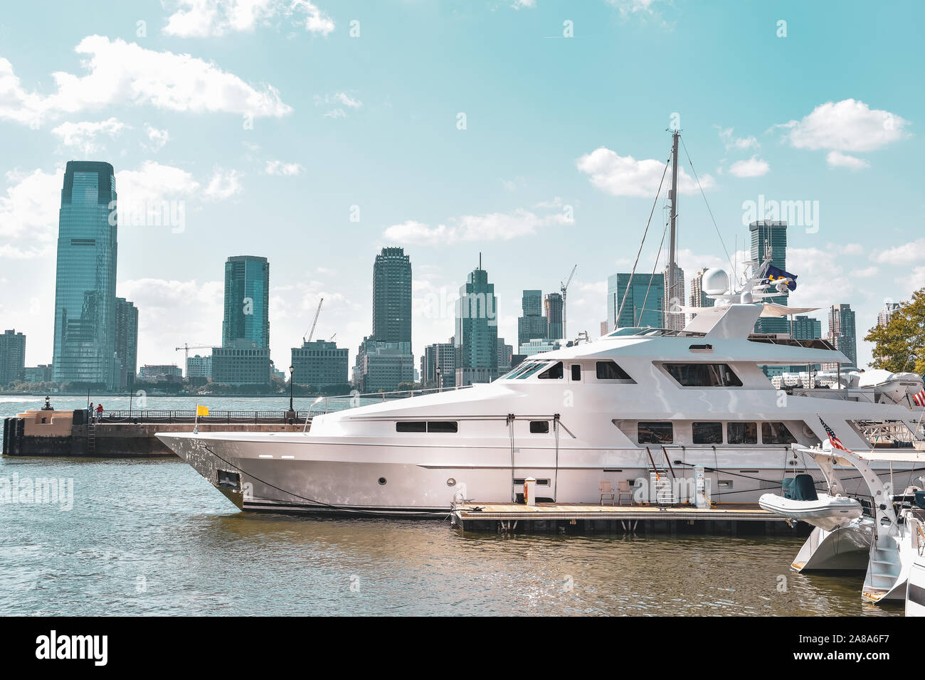 New Jersey skyline from Battery Park in a sunny day. Luxury yacht in the foreground. City, travel and luxury concept. Manhattan, New York City, USA. Stock Photo