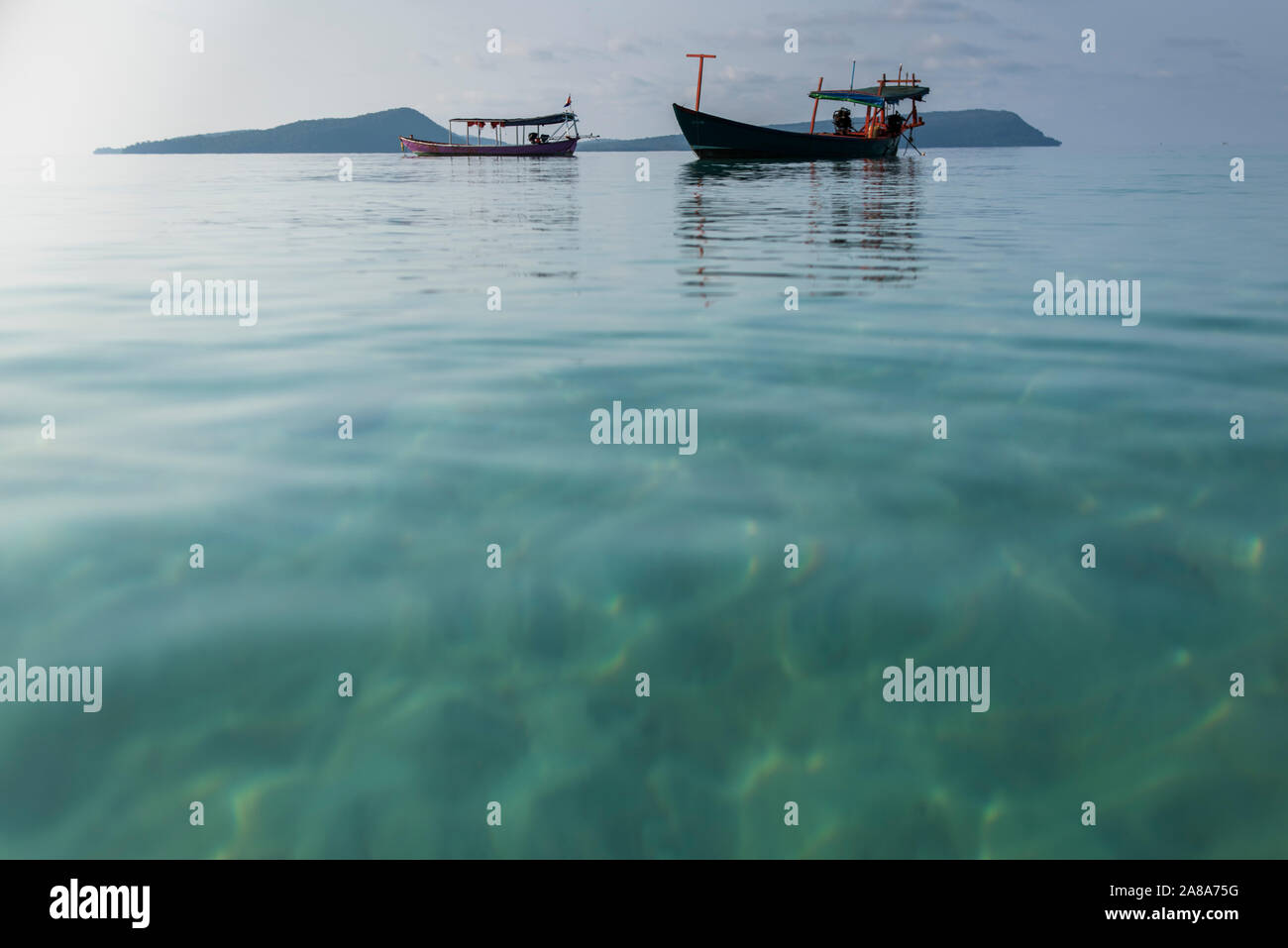 Koh Rong Fish Both Low perspective view of traditional fishing boats at the Tui beach of ...