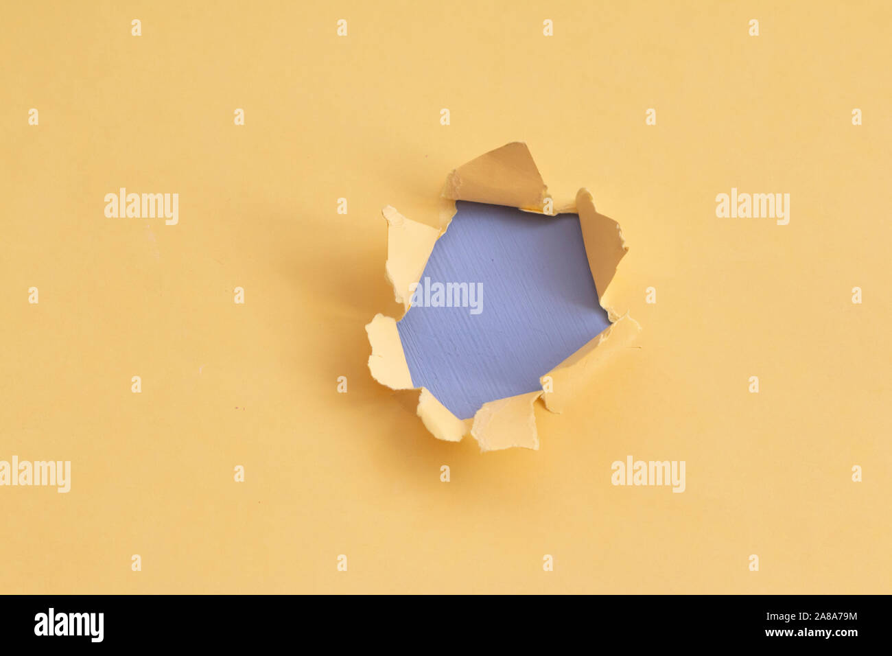 Damaged yellow paper with light blue background, space for text Stock Photo