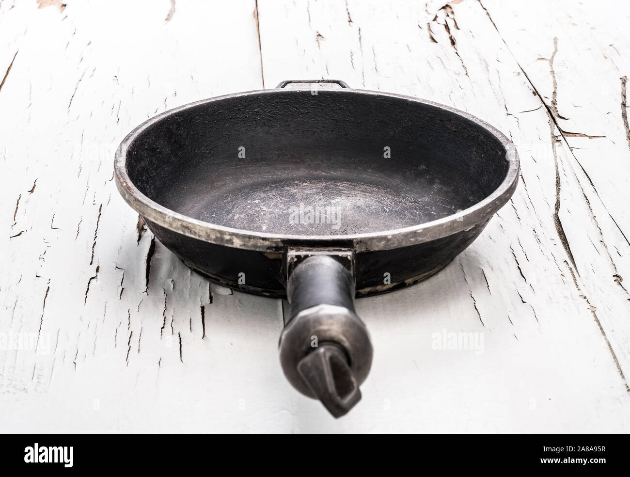 Empty cast iron frying pan on white background Stock Photo