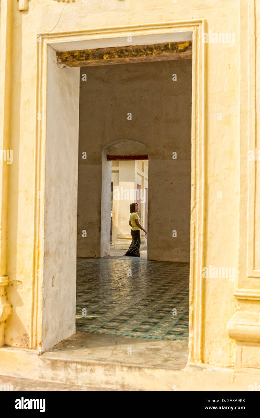 Woman tourist guide in the archways at the Shwe Zi Gon Pagoda Bagan Myanmar Burma Stock Photo