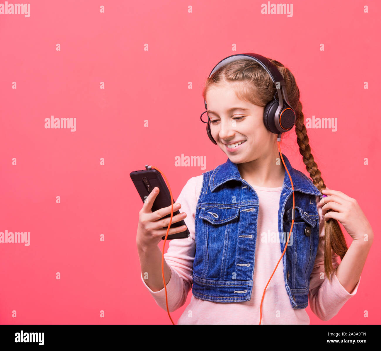 Teenage girl listening to music in big headphones Stock Photo Alamy