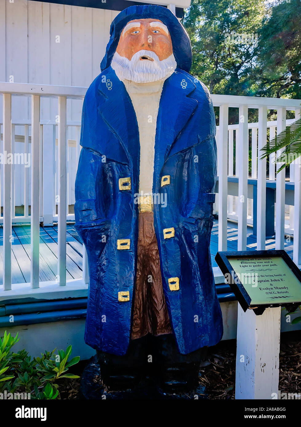 A statue of an old fisherman, dressed in a Navy pea coat and rain