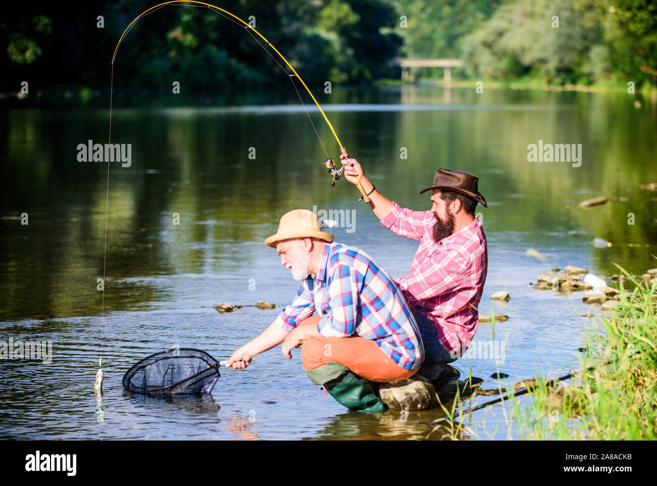 https://c8.alamy.com/comp/2A8ACKB/hunting-happy-fishermen-friendship-catching-and-fishing-two-male-friends-fishing-together-retired-dad-and-mature-bearded-son-fly-fish-hobby-of-men-in-checkered-shirt-retirement-fishery-2A8ACKB.jpg