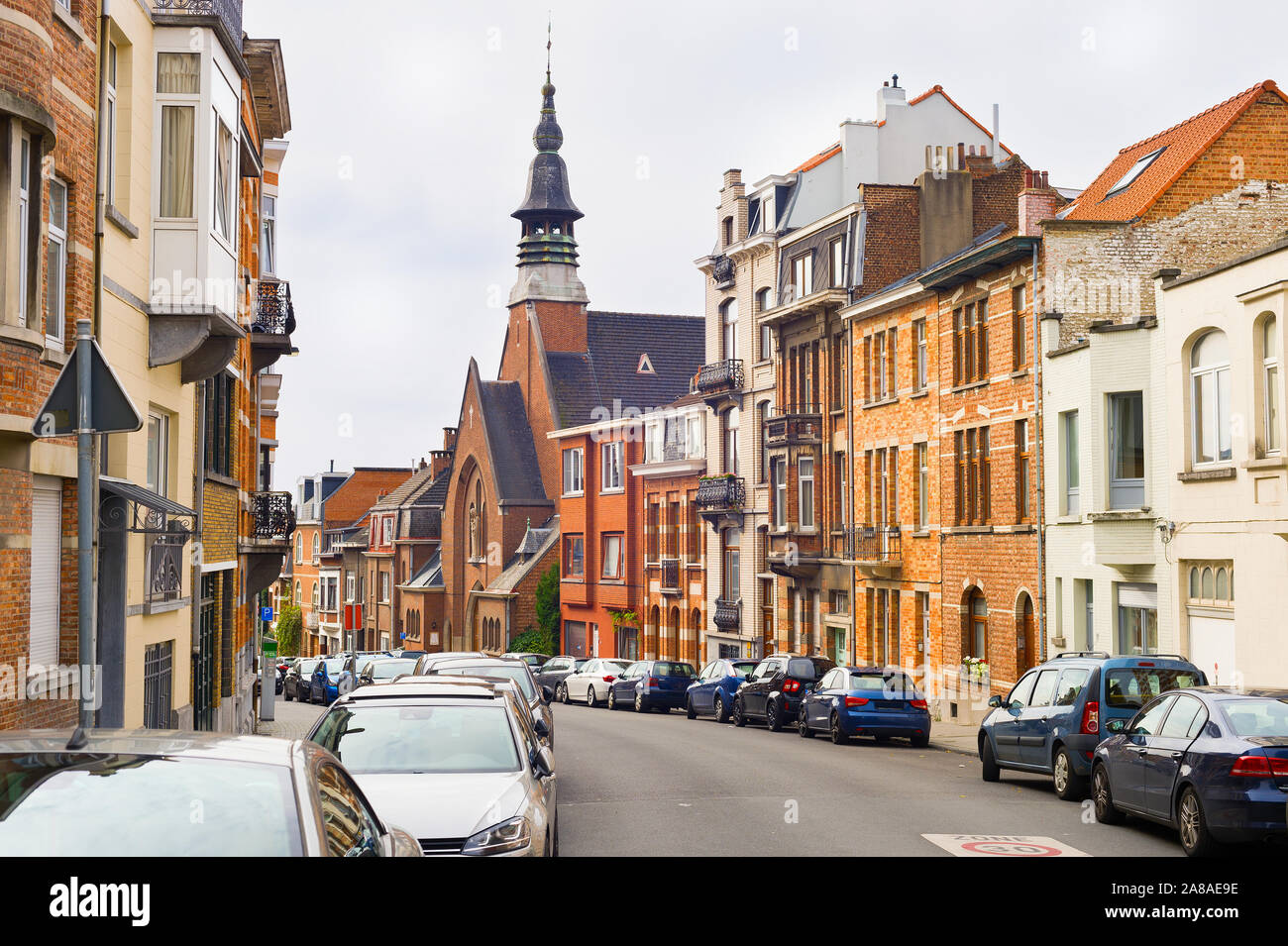 Brussels traditional architecture street. Cars parked by the buildings