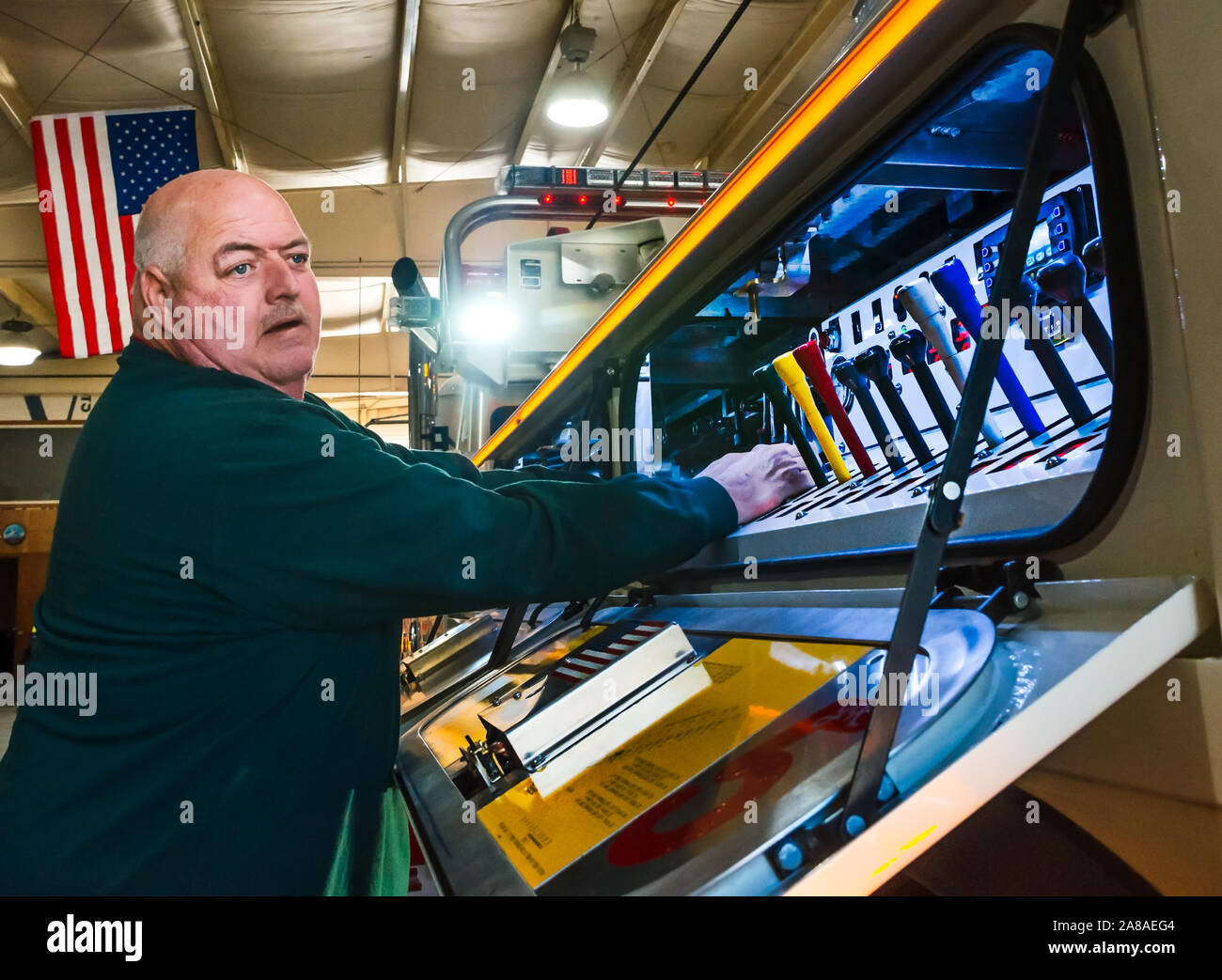 Mike Adams, of Mike Adams Towing and Air Cushion Recovery, operates the controls of his newest truck, a 2016 Mack Granite, in Macon, Georgia. Stock Photo