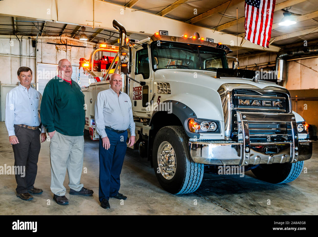 Mike Adams (center) stands beside Tommy Bush, left, account manager at Nextran Truck Centers, and David Bennett, right, general manager at Nextran. Stock Photo