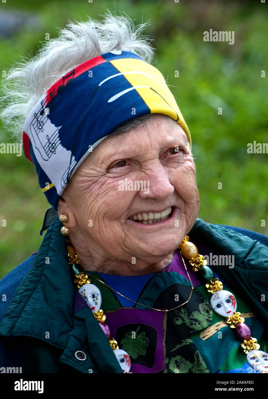 An elderly woman smiles as she watches the annual Mardi Gras parade March 6, 2011 in Grand Isle, Louisiana. Stock Photo