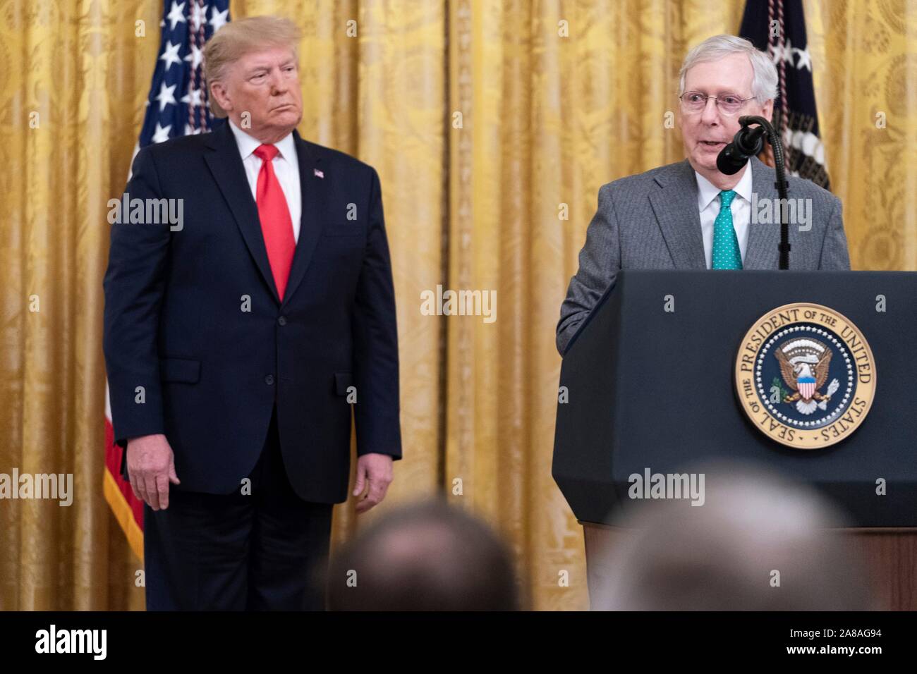 U.S. President Donald Trump listens as Senator Majority Leader Mitch McConnell delivers remarks on the federal judicial confirmation milestones in the East Room of the White House November 6, 2019 in Washington, DC. Stock Photo
