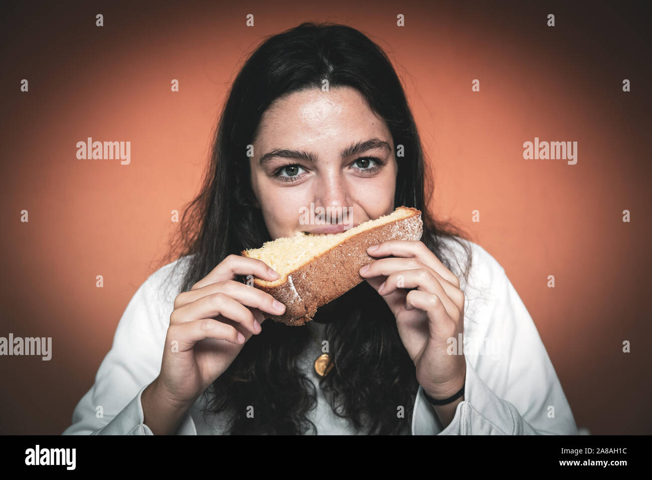 Young woman eating a slice of Christmas cake Stock Photo