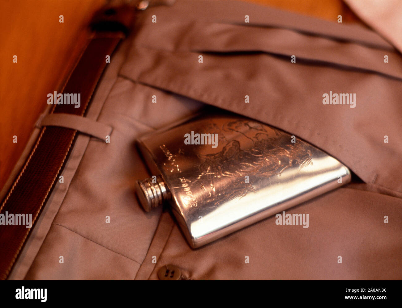 Close-up of hip flask in pocket of brown trousers, Barcelona, Spain Stock Photo