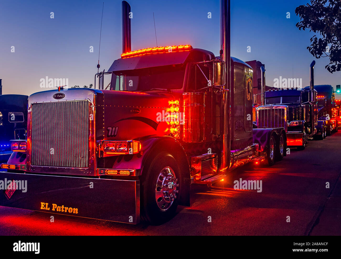 A 2000 Peterbilt 379, leads the way during the light show contest during the 34th annual Shell Rotella SuperRigs in Joplin, Missouri. Stock Photo