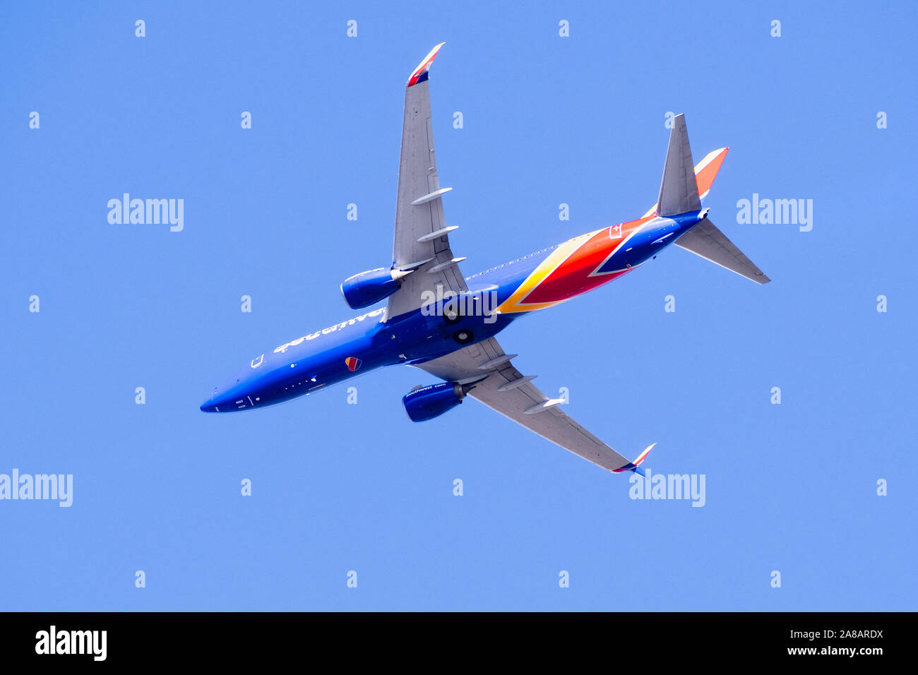 Oct 20, 2019 San Jose / CA / USA - Southwest Airlines aircraft in flight; the Southwest Airlines heart Logo visible on the airplanes' underbelly; blue Stock Photo