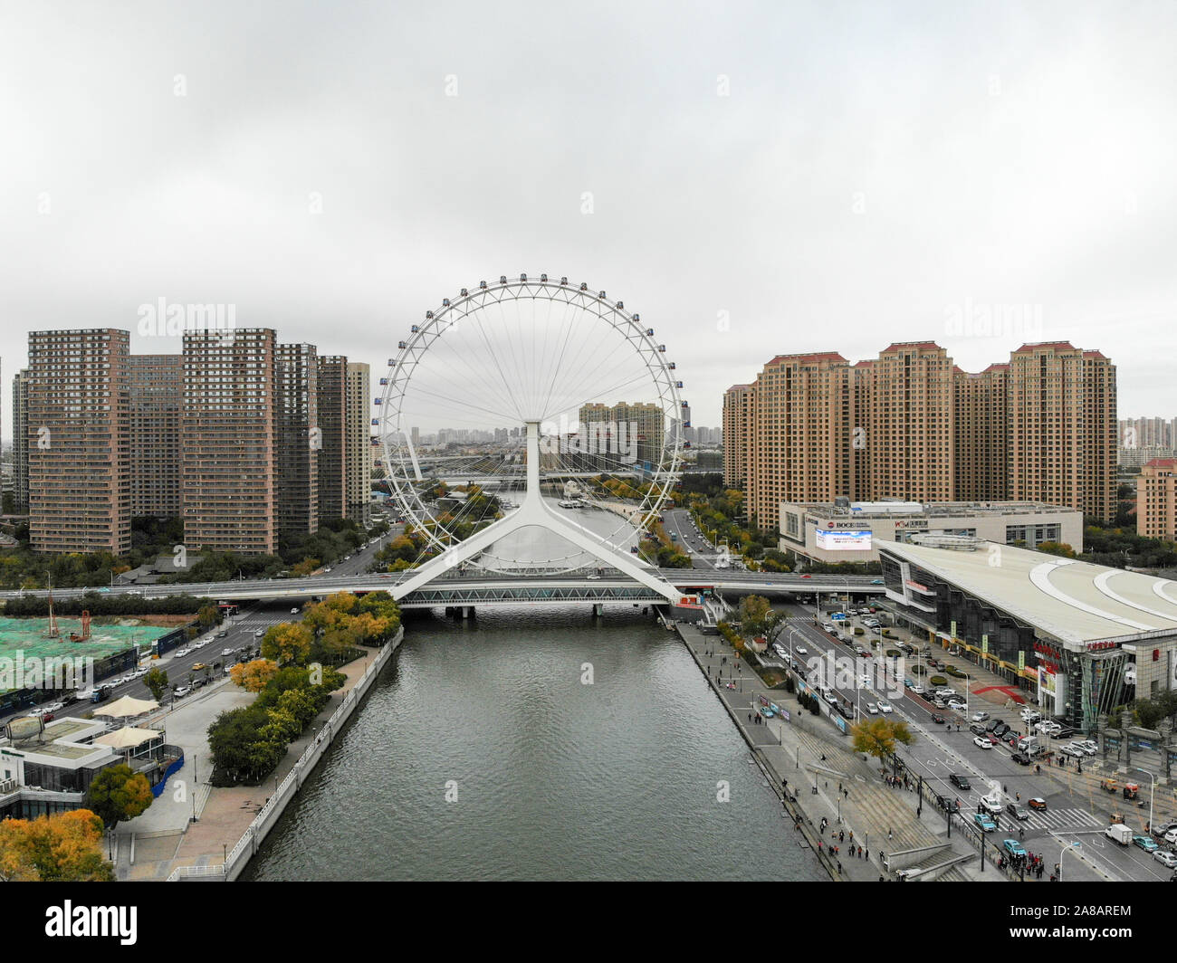 Aerial view cityscape of Tianjin ferris wheel. Famous Tianjin Eye ferris wheel above the Yongle Bridge and the Haihe river. Popular modern landmark in Tianjin, China. October, 28th, 2019 Stock Photo