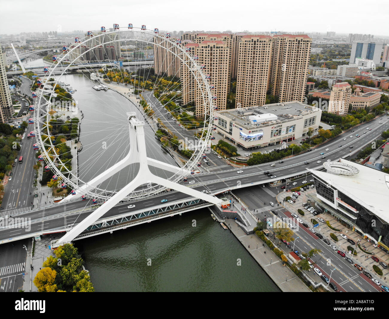 Aerial view cityscape of Tianjin ferris wheel. Famous Tianjin Eye ferris wheel above the Yongle Bridge and the Haihe river. Popular modern landmark in Tianjin, China. October, 28th, 2019 Stock Photo