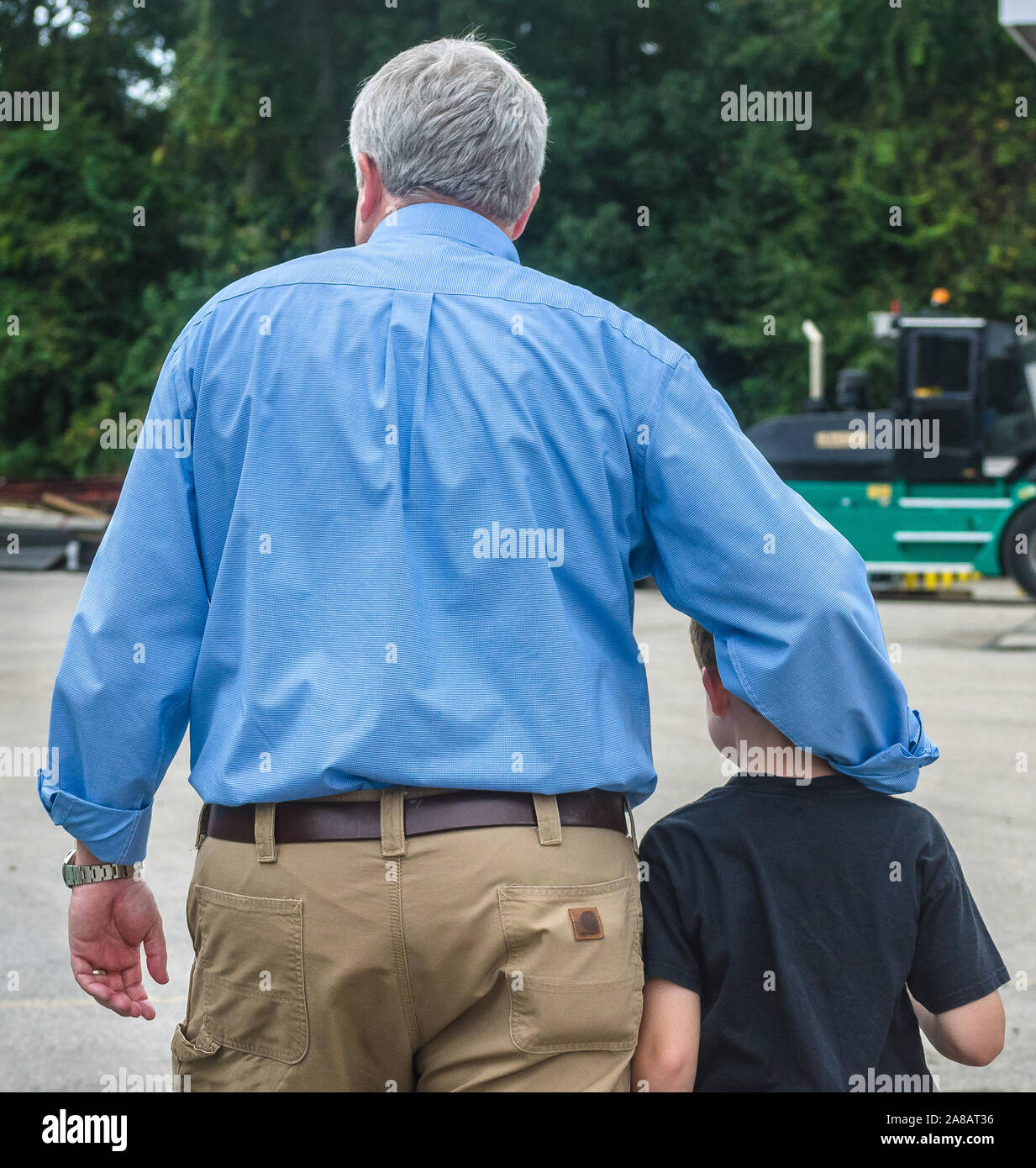 A man walks with his son at Superior Transportation, Sept. 30, 2015, in North Charleston, South Carolina. Stock Photo