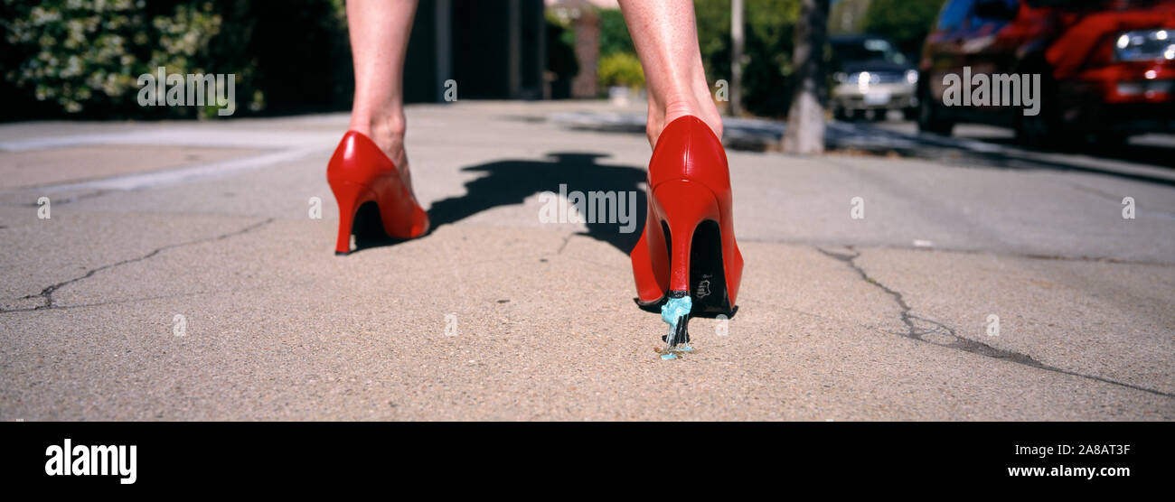 Bubble gum stuck to the heel of a woman's shoe Stock Photo