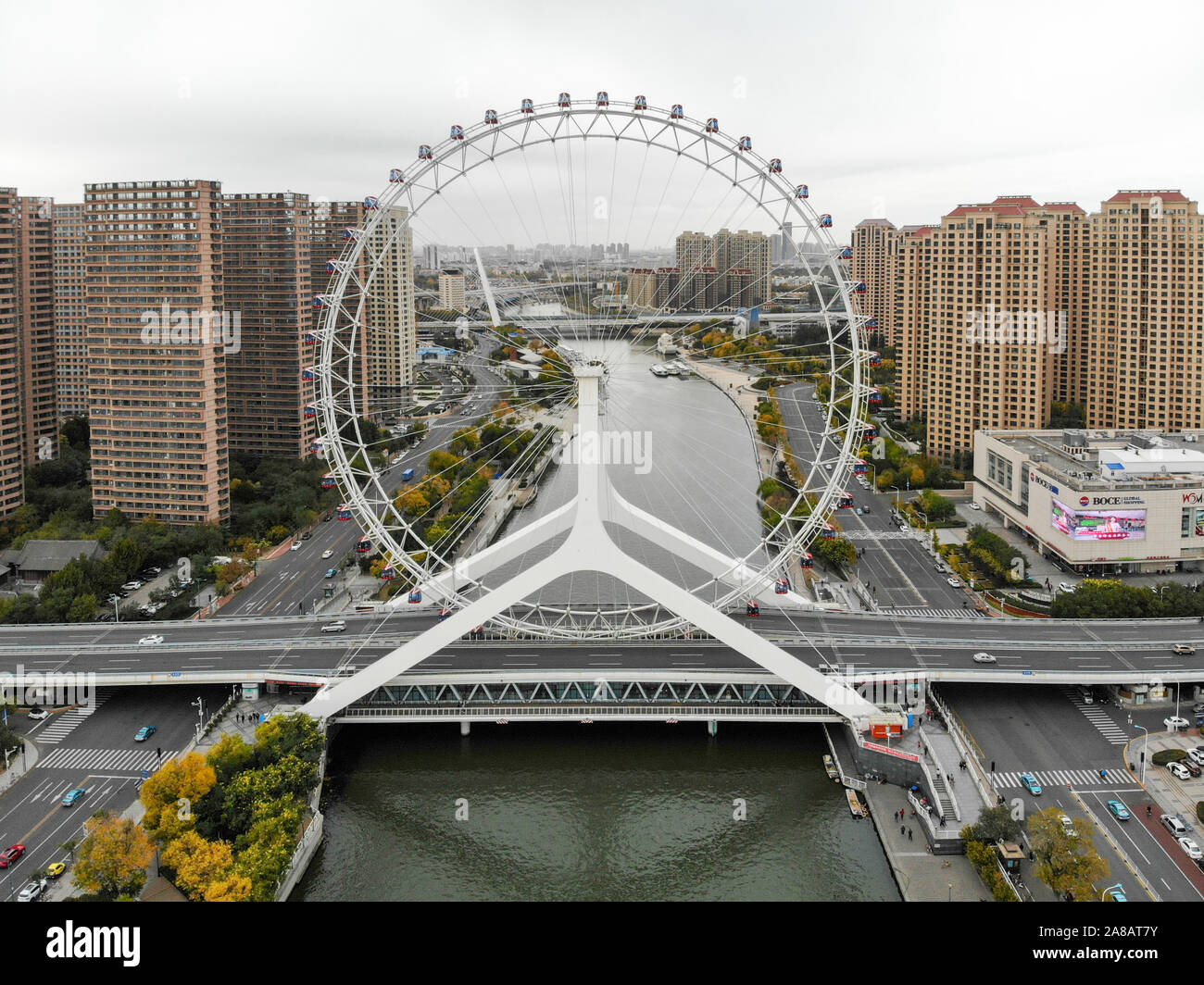 Aerial view cityscape of Tianjin ferris wheel. Famous Tianjin Eye ferris wheel above the Yongle Bridge and the Haihe river. Popular modern landmark in Tianjin, China. October, 28th, 2019 Stock Photo