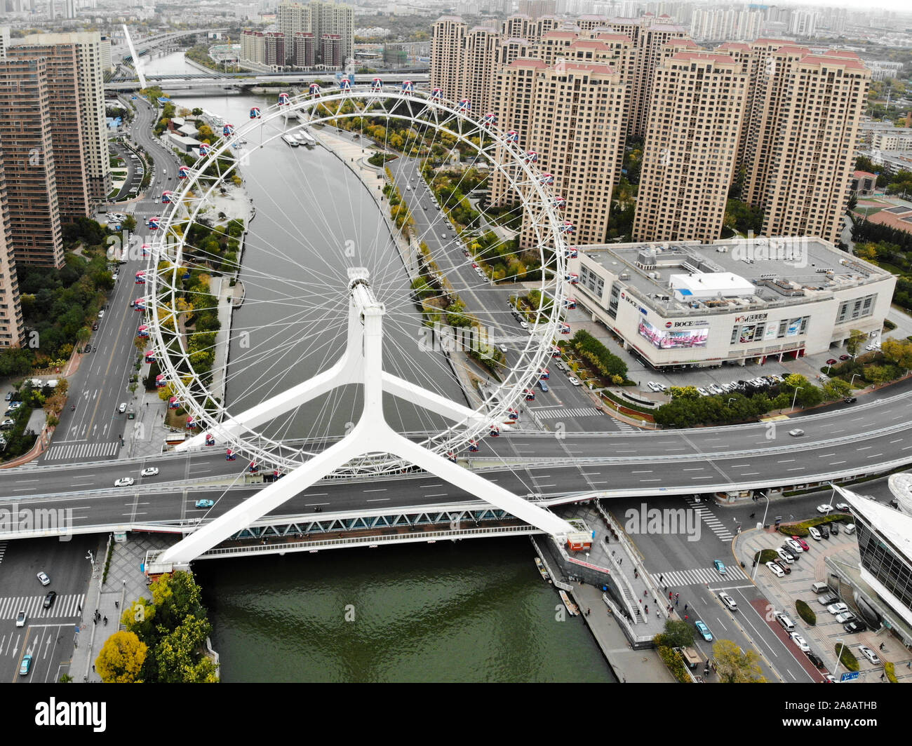 Aerial view cityscape of Tianjin ferris wheel. Famous Tianjin Eye ferris wheel above the Yongle Bridge and the Haihe river. Popular modern landmark in Tianjin, China. October, 28th, 2019 Stock Photo