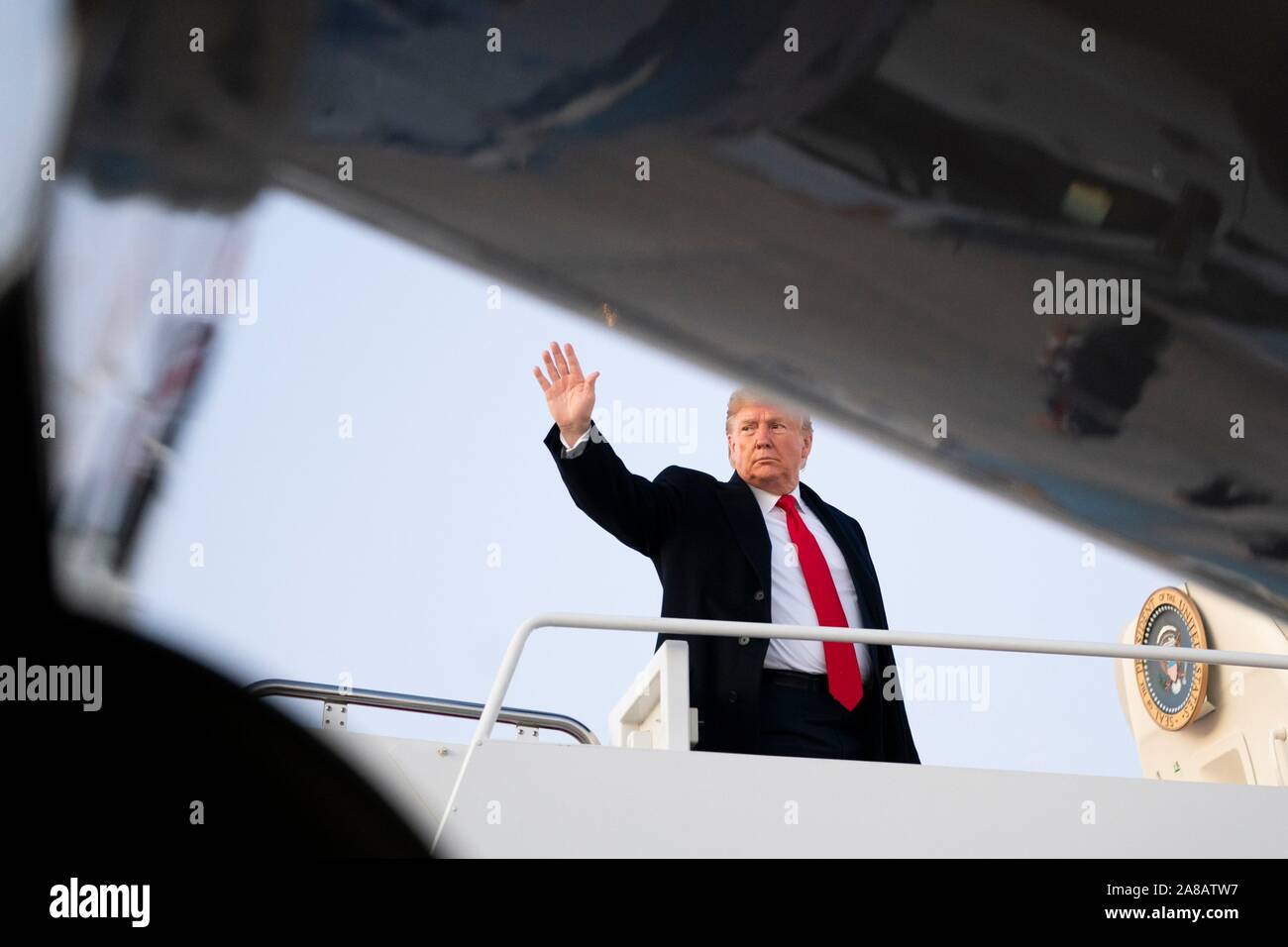 U.S. President Donald Trump waves as he boards Air Force One for departure to Louisiana at Joint Base Andrews November 6, 2019 in Clinton, Maryland. Stock Photo