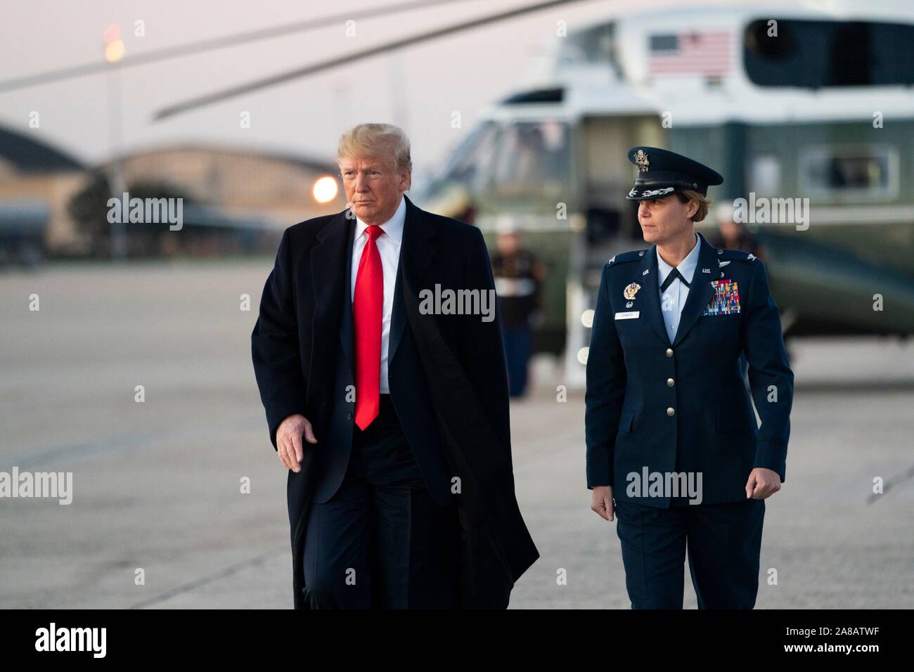 U.S. President Donald Trump disembarks Marine One escorted to Air Force One by Col. Rebecca Sonkiss at Joint Base Andrews November 6, 2019 in Clinton, Maryland. Stock Photo