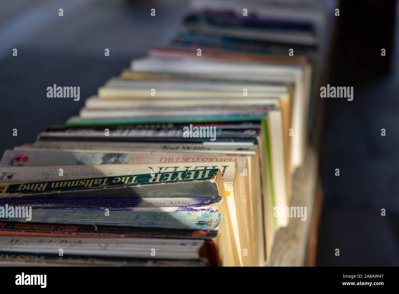 a row of old books on a wall outside a book shop Stock Photo