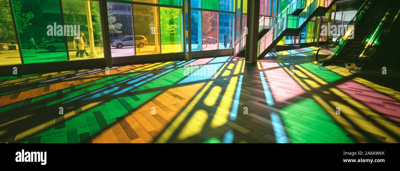 Sunlight illuminating interior of convention center through colorful stained glass windows, Quebec, Canada Stock Photo