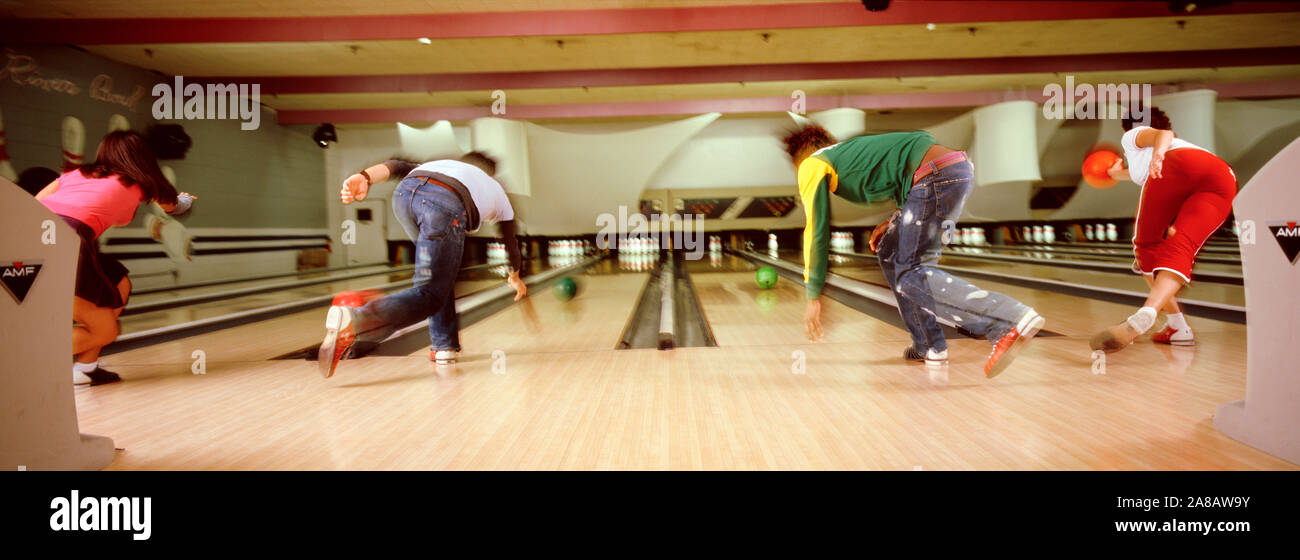 Young people playing in bowling alley, USA Stock Photo