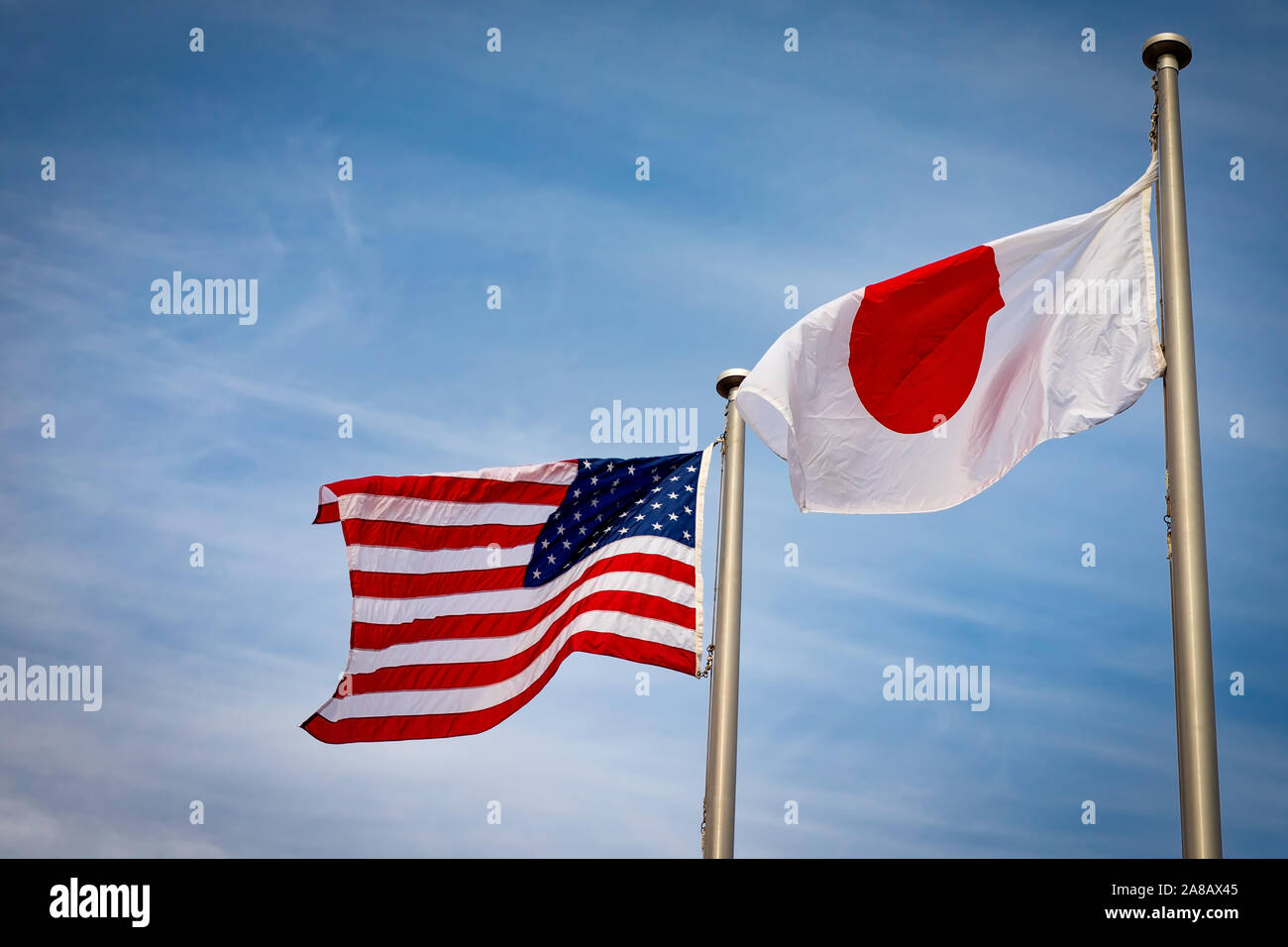 The American and Japanese flags fly side by side in Yokosuka, Japan. Stock Photo
