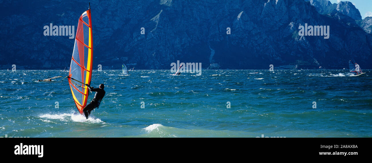 Side profile of a person windsurfing, Lake Garda, Italy Stock Photo