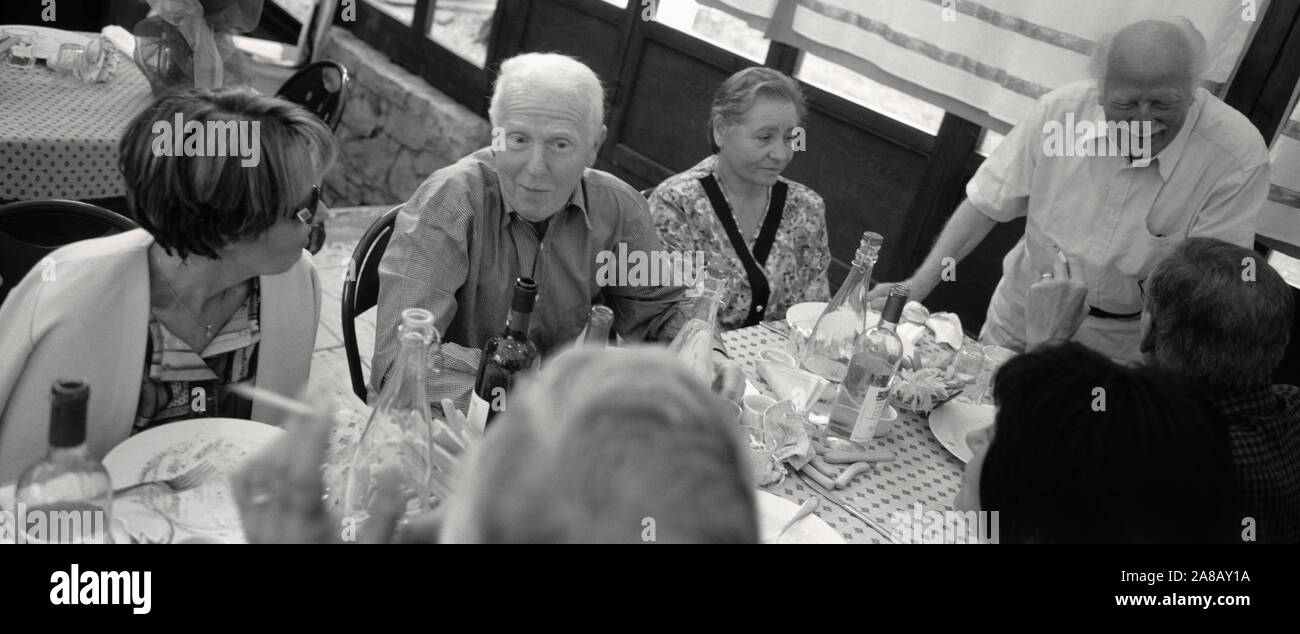 High angle view of two senior men and two senior women at a dining table, Italy Stock Photo