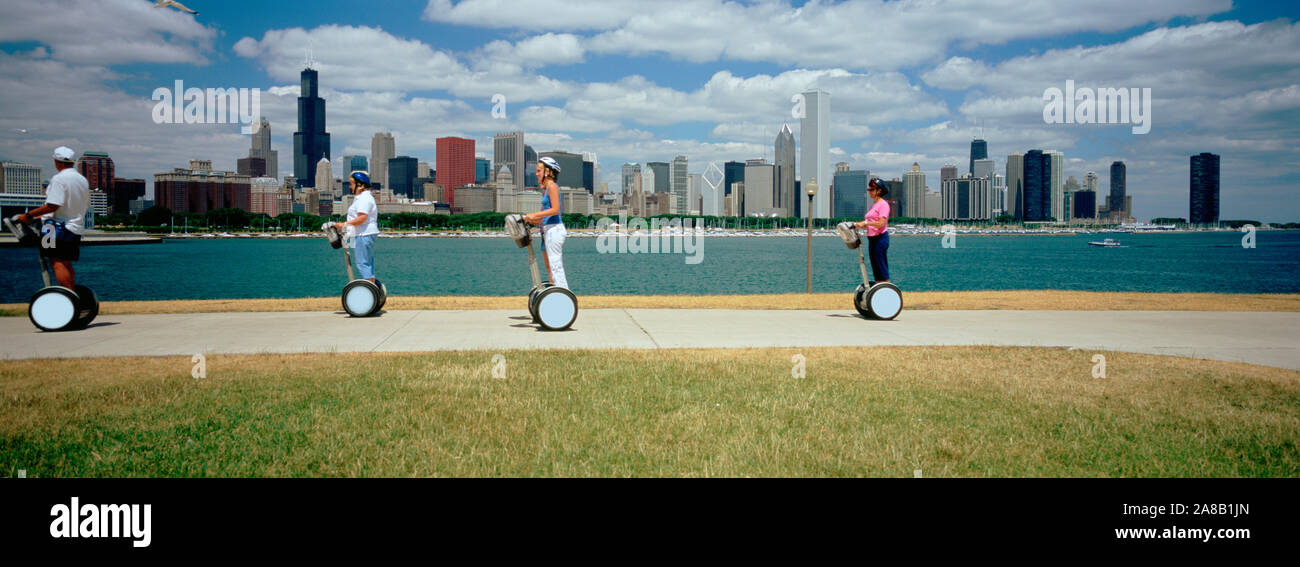 Side profile of four people riding segways, Chicago, Illinois, USA Stock Photo