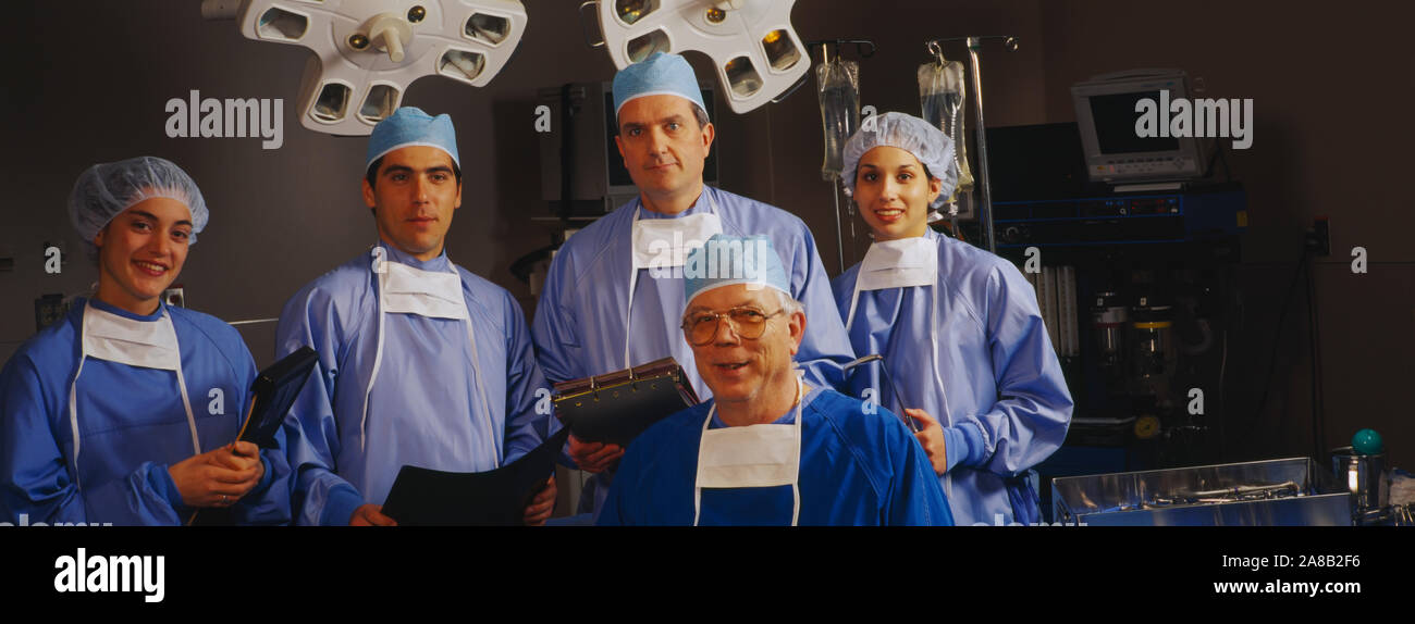 Portrait of five surgeons in an operating room Stock Photo
