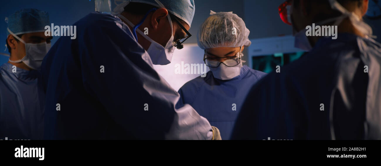 Four Surgeons In An Operating Room, Hospital Stock Photo