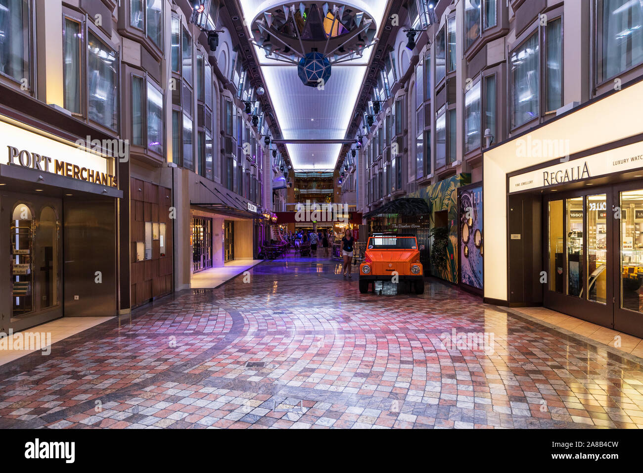 The Royal Promenade, aboard a Royal Caribbean cruise ship, features multiple restaurants and stores to shop in for the guests aboard. Stock Photo