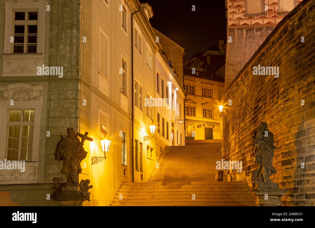 Prague - The stairs Radnické schody with the statues of St. Joseph and St. John the Nepomuk under the Castle at night. Stock Photo