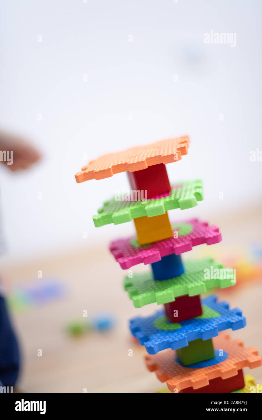 Preschooler child playing with colorful toy blocks. Kid playing with ...