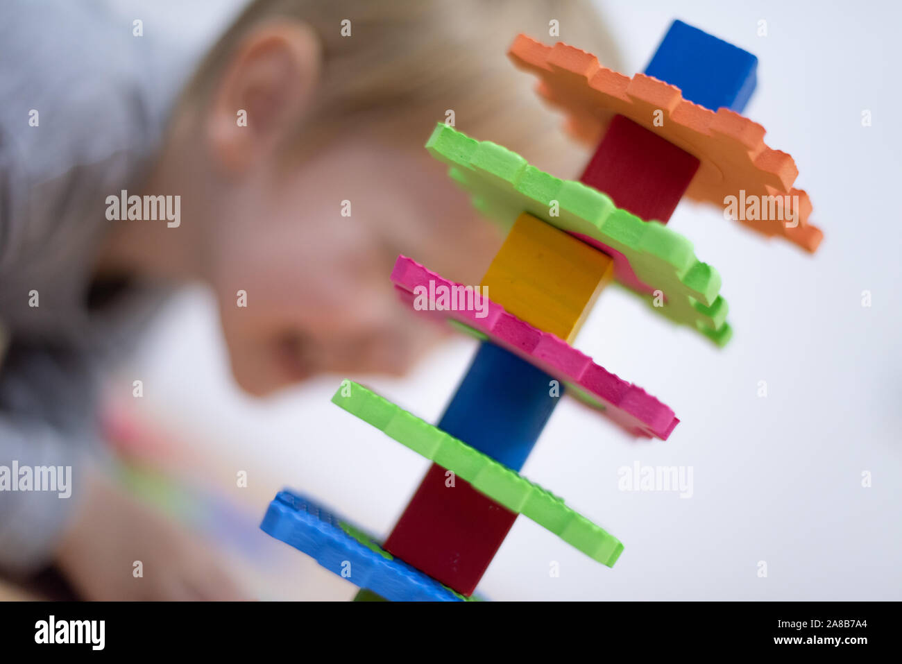 Preschooler child playing with colorful toy blocks. Kid playing with ...